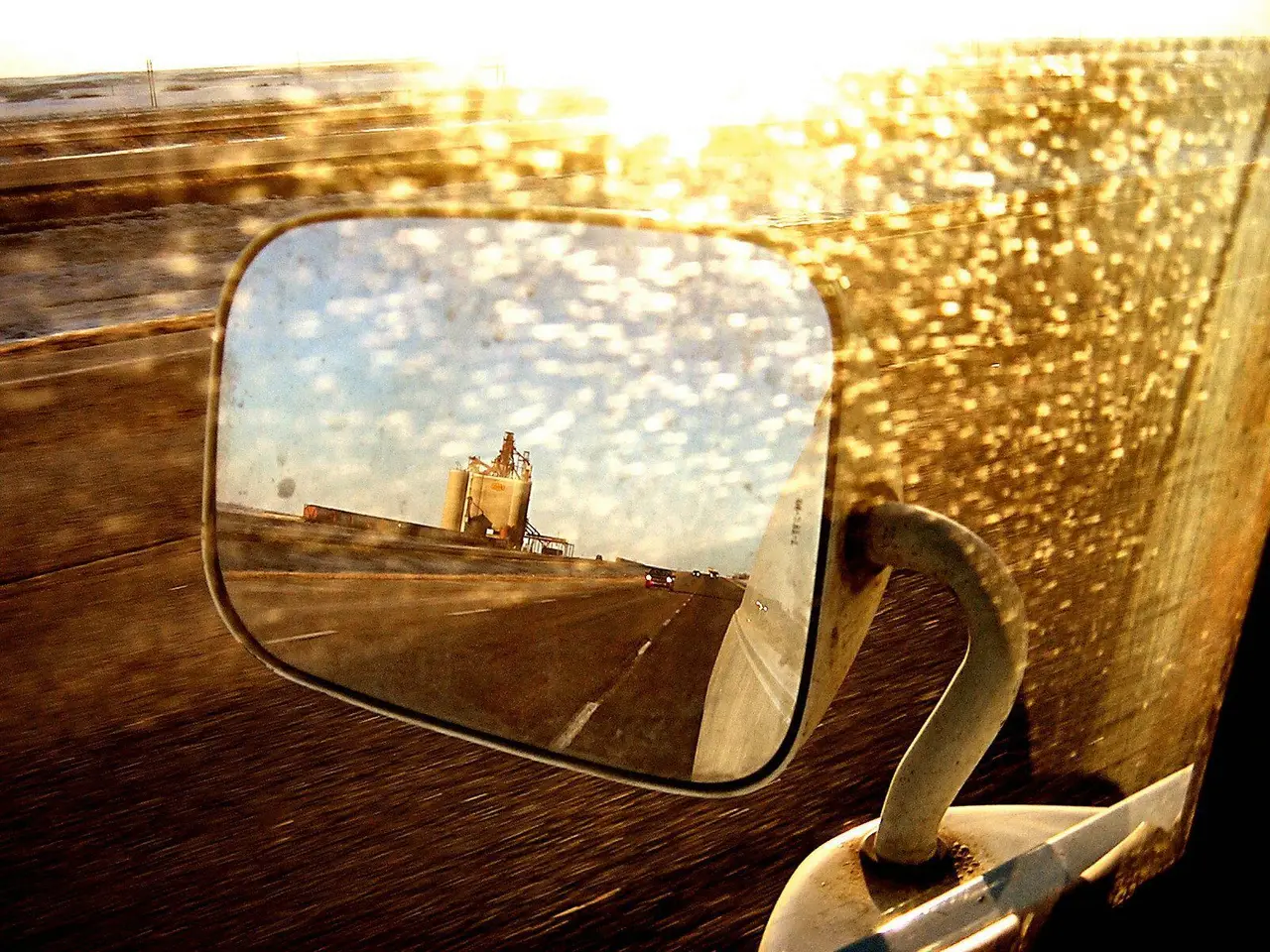 Grain elevator reflected in a truck mirror on Highway 16, 2008